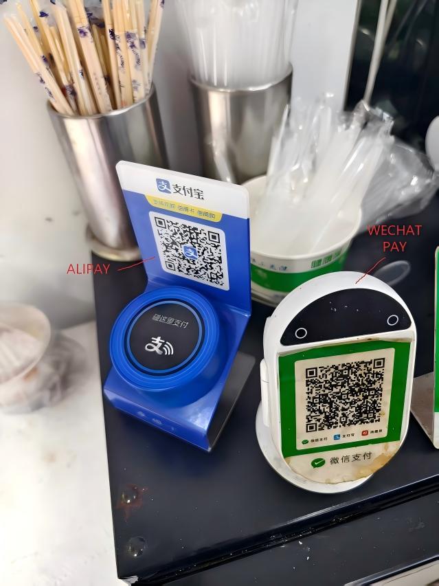 Side-by-side: Alipay QR code (blue) on the left, WeChat Pay QR code (green) on the right