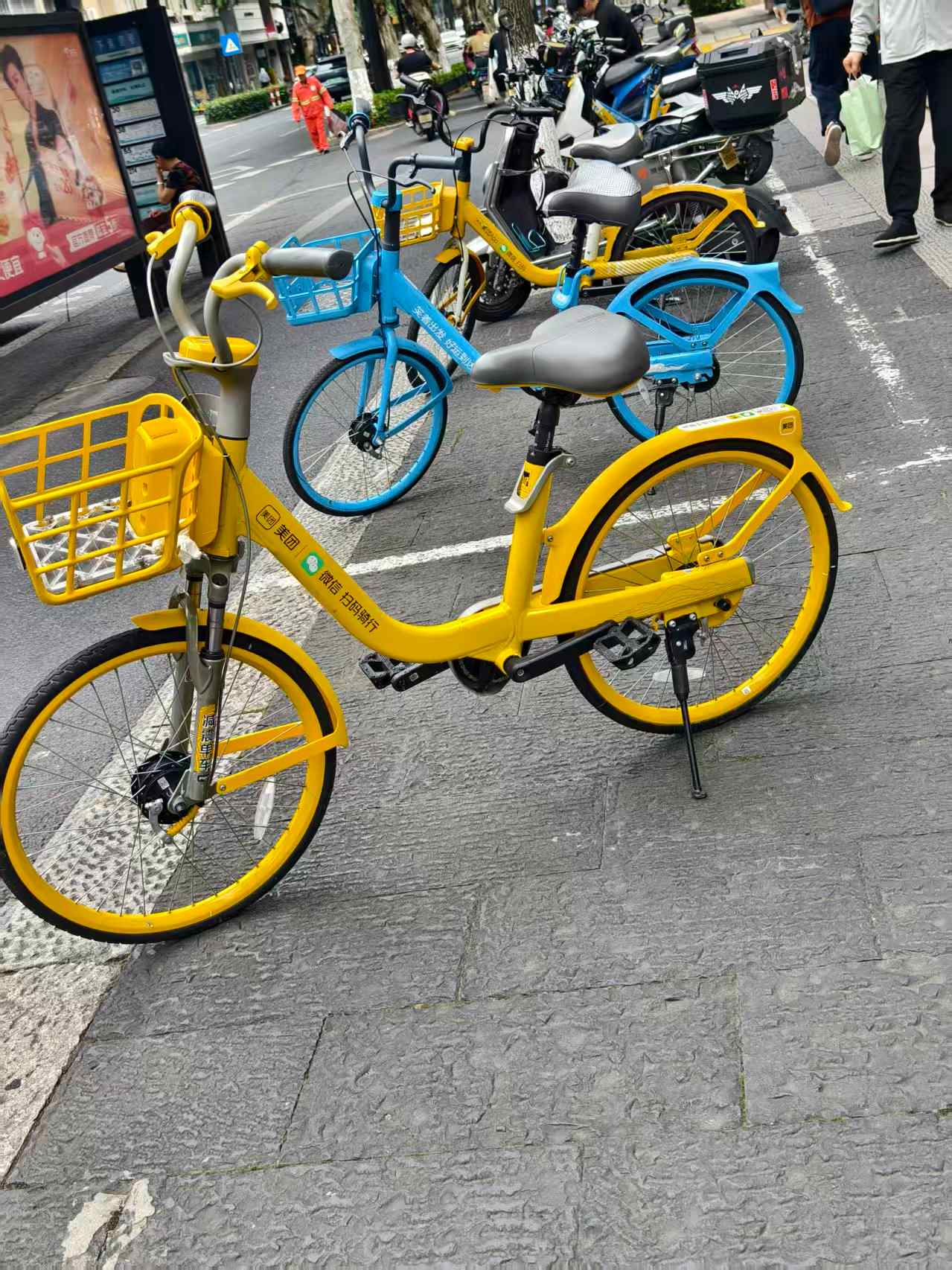 Yellow Meituan Bike parked on a street in China