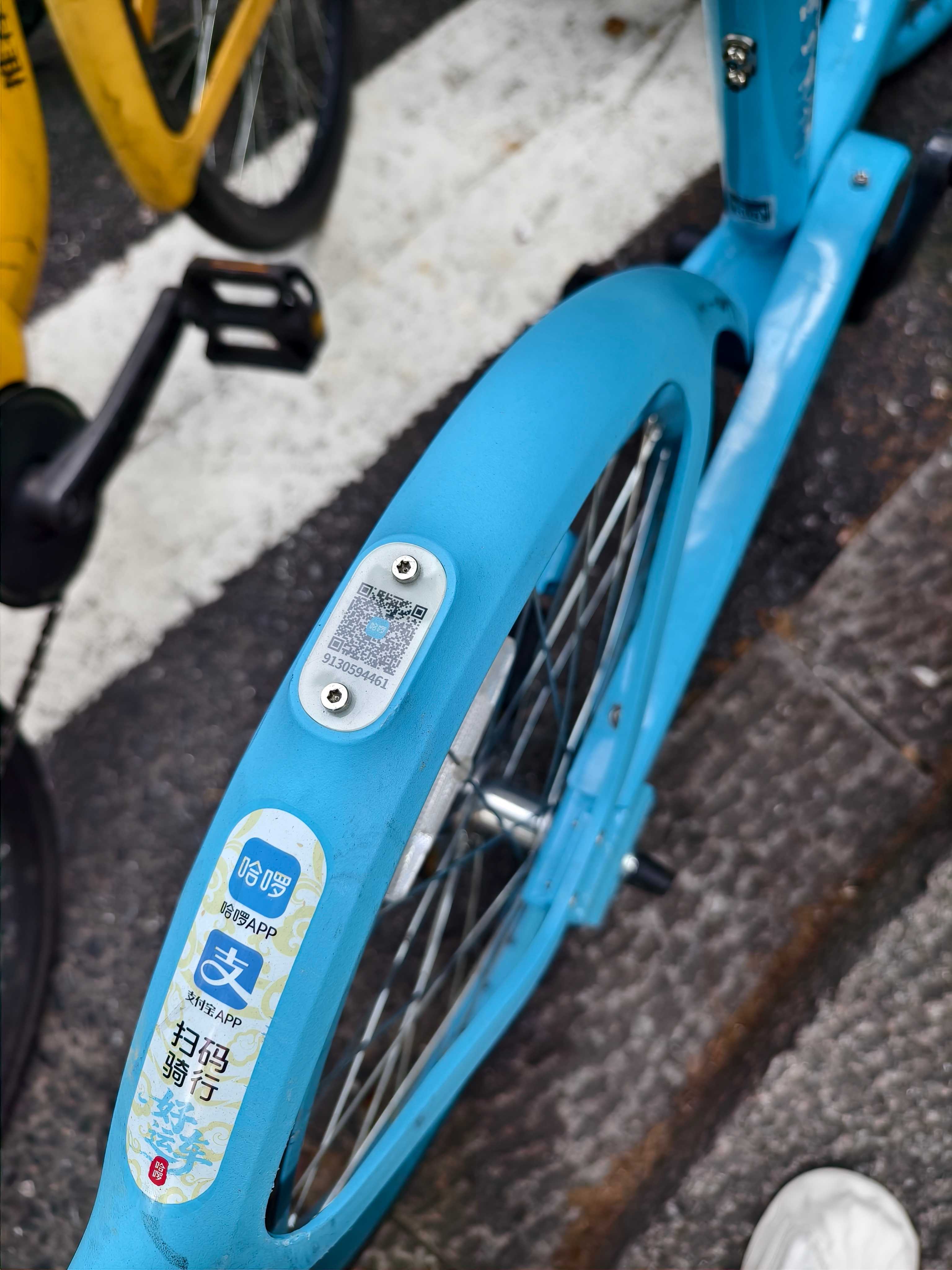 QR code on the rear mudguard of a shared bike being scanned