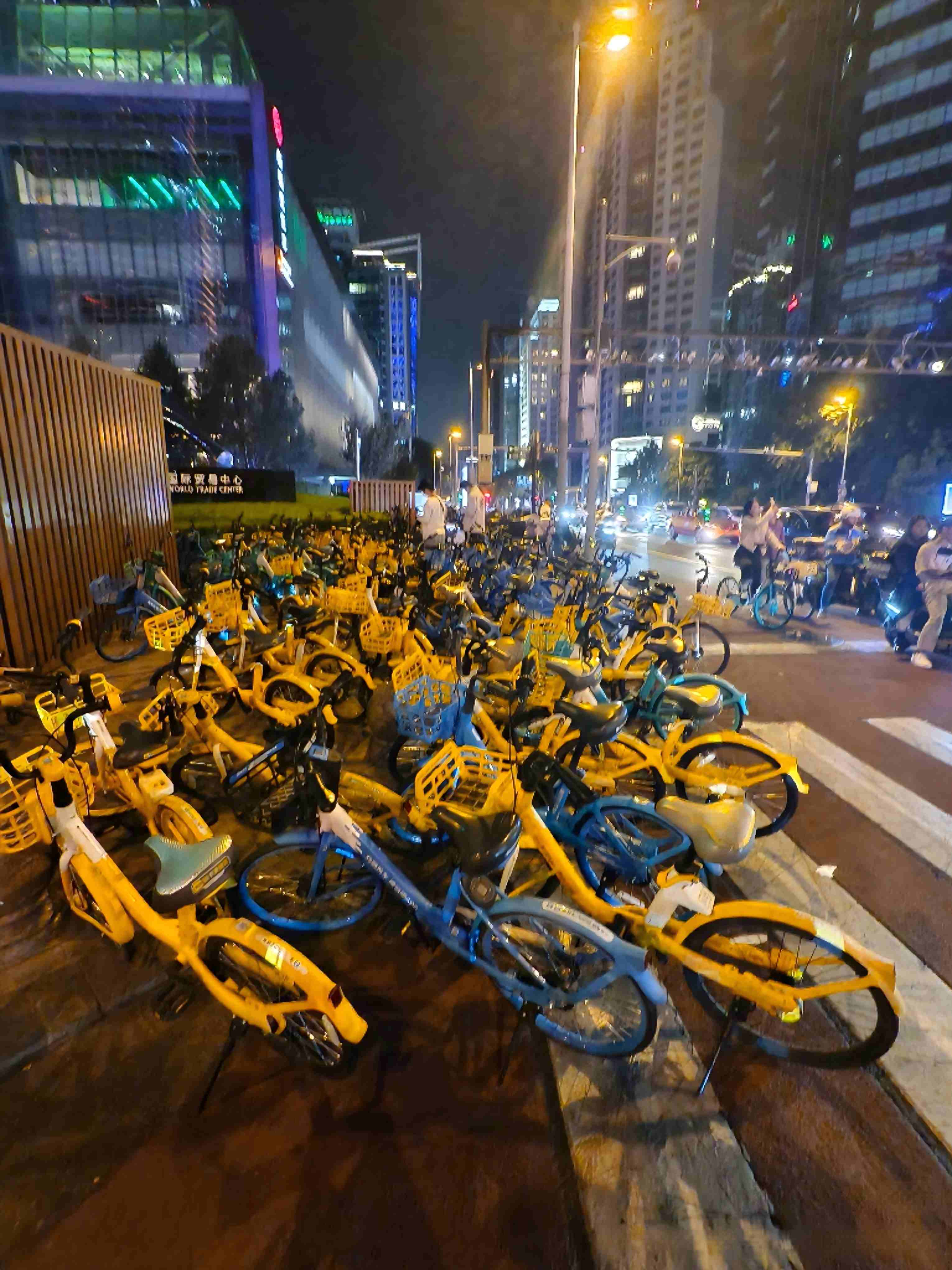 Rows of shared bikes parked along a city street