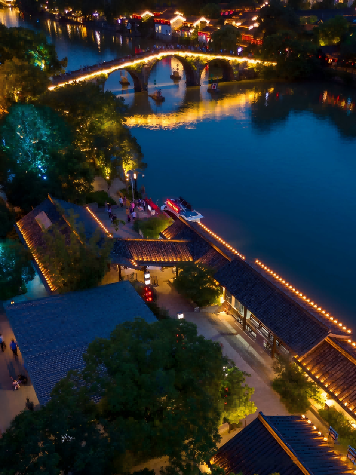 The Grand Canal at night — Gongchen Bridge, red lanterns, and canal-side tables